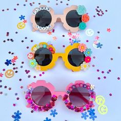 "These personalizable sunglasses are the perfect for your littles this spring and summer! There are many colors to choose from, and the customization possibilities are endless! Add your child's name, or a cute phrase like \"flower power\", \"sunflower cutie\", \"mini\", etc.  These make a great gift for events, baby showers, photoshoots, sleepovers, birthday parties and more! HOW TO ORDER: 1. Choose the color of sunglasses 2. Select your style * If personalized add your customization in the personalization box (max of 10 characters) *The flowers will be chosen based off of the sunglasses color you choose - we will choose whatever matches them the best! NOTE: additional customization is available please message me for further details. * Anti-Glare * UV Protection (UVA & UVB) * Durable and s Fun Spring Festival Sunglasses, Fun Multicolor Sunglasses For Spring, Fun Multicolor Spring Sunglasses, Playful Multicolor Sunglasses For Spring, Custom Name Sunglasses For Summer Beach, Custom Name Sunglasses For Beach In Summer, Custom Name Pink Sunglasses With Adjustable Fit, Fun Summer Festival Sunglasses, Pink Sunglasses With Custom Name And Adjustable Fit