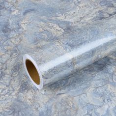 a roll of silver marble paper sitting on top of a table