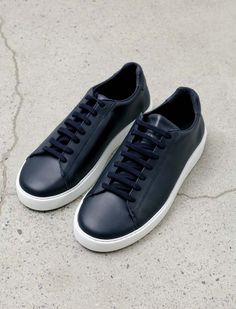 A classic tennis-style sneaker in navy blue leather. features flat cotton laces in navy and a contrasting white rubber sole. subtle logo stamp on the tongue.    - made in portugal  - 100% leather Navy Blue Sneakers, Leather Sneakers Men, Tennis Style, Navy Sneakers, Norse Projects, Blue Sneakers, Sneakers Outfit, Logo Stamp, Cotton Lace