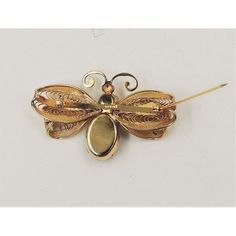 This is part of Chairish’s Costume Jewelry assortment.  Late 1950s goldtone round and oval faux-topaz fly with filigree wings brooch with security clasp. Marked "Napier." Measures: 1 3/8 inches long by 2 1/4 inches wide.  Condition: Very good; some metal wear mostly to the back.  Please reference the measurements noted in the description above for the best approximate dimensions. Please reach out to the seller under "Ask the Seller" for specific questions regarding the measurements. Oval Gold Filigree Brooch, Gold Oval Filigree Brooch, Gold Filigree Oval Brooch, Antique Gold Oval Brooches, Antique Gold Oval Brooch, Gold Filigree Brooches Collectible, Gold Filigree Brooches For Collectors, Vintage Yellow Gold Filigree Brooches, Collectible Gold Filigree Brooches