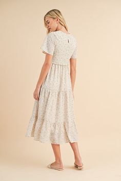 Floral smocked midi dress in ecru-NEW – JanieLanie Daywear Flutter Sleeve Midi Dress With Smocked Bodice, Beige Maxi Dress With Smocked Bodice And Midi Length, Cream Midi Dress For Summer In Modest Style, Modest Cream Midi Dress For Summer, Casual Flowy Midi Dress With Tiered Skirt, Casual Midi Dress With Ruffle Hem, Feminine Tiered Dress With Elastic Waistband, Cream Midi-length Smocked Dress, Chic Flowy Smock Midi Dress