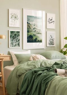 a bedroom with green bedding and pictures on the wall