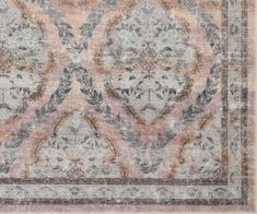 an old rug with floral designs on the middle and bottom, in pink tones is shown