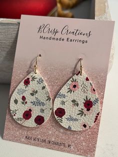 Celebrate the vibrancy of spring with these Floral Earrings. Crafted from faux leather in a teardrop shape, these small earrings feature a delightful combination of colorful flowers, making them the perfect accessory to add a touch of floral elegance to your summer style. Each pair is made for sensitive ears with hypoallergenic and nickle free hooks and a secure backing. Spring Trendy Teardrop Earrings, Trendy Teardrop Earrings For Spring, Spring Gift Teardrop Dangle Earrings, Spring Teardrop Earrings As A Gift, Spring Adjustable Teardrop Earrings, Spring Teardrop Earrings With Ear Wire, Teardrop Earrings With Ear Wire For Spring, Earrings Teardrop, Faux Leather Earrings