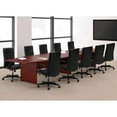 an empty conference table with black chairs and a flat screen tv