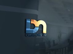 the logo for creations co is displayed on a wall in an office building with dark walls