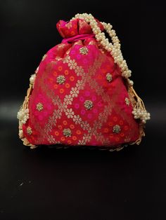 "traditional indian wedding delicate gota patti embroider gifting potli bag giveaways | rani pink drawstring purse with beaded chain Package Contents: 1 Size: 10\" x 8\" Designed with the heart, this beautiful Potli or batawa bag are eye catchy and made of premium material. Key Features: Embroidery art work. This potli is good match with both Indian and western outfits and are superb for wedding and festive parties. This would be best complement to your designer saree, lenhga or any other kind o Gold Potli Bag With Mirror Work For Gift, Bollywood Style Potli Bag With Mirror Work For Festivals, Bollywood Style Diwali Potli Bag With Mirror Work, Diwali Mirror Work Potli Bag, Diwali Potli Bag With Mirror Work, Festive Gold Potli Bag With Mirror Work, Wedding Festive Potli Bag With Mirror Work, Festive Pink Clutch As Gift, Red Zari Work Potli Bag For Party