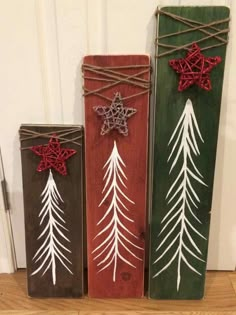 three wooden boxes with christmas decorations on them