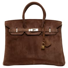 This Hermès Birkin 35CM, crafted from rich Chocolate Veau Doblis suede, exudes timeless elegance and refined luxury. The soft and velvety texture of the Doblis suede beautifully complements the warm, gleaming gold hardware, creating a sophisticated yet understated look. The classic Birkin silhouette, known for its structured shape and versatility, makes this a statement piece that can transition seamlessly from day to night. The bag features the iconic double rolled handles, front flap with a si Rare Birkin Bag, Vintage Birkin Bag, Brown Birkin Bag, Suede Birkin, Hermes Birkin Bag 25, Hermes Birkin Brown, Vintage Birkin, Chicago Townhouse, Vintage Hermes Bag