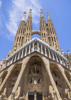 people are standing in front of a very tall building that is being constructed into the shape of a cathedral