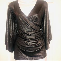 New! Never Been Worn! Gorgeous Gunmetal Gray Shimmery Top With Cold Shoulders.V Neck Blouse.Blouse Gathers On The Side So You Actually Put The Blouse On Over Your Head. Wonderful To Wear To A Holiday Event Or Just With Jeans. 92% Polyester 8% Elastane Metallic Fitted V-neck Top, Shimmer V-neck Top For Evening, Glamorous Evening Tops With Sheen, Evening Shimmer V-neck Top, Glamorous Sheen Tops For Evening, Metallic Shimmer Tops For Holidays, Metallic Shimmer Tops For Holiday, Metallic Shimmer Top For Holiday, Glamorous Metallic Shimmer Blouse