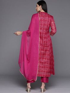 Grab this beautiful 3-piece set. The set comes with bandhani print & zari embroidery anarkali kurta has mandarin collar, 3/4th sleeves & calf length teamed with solid trouser pant with elasticated waistband & slip-on closure and a silk chiffon dupatta with lace detailing. Color - Pink Kurta Fabric-Cotton Blend Bottom Fabric-Silk Blend Dupatta Fabric - Silk Chiffon Neck-Mandarin Colar Sleeves-3/4th Sleeves Work - Bandhani Print & Zari Embroidery Washing Instructions-Hand Wash DISCLAIMER - The color of the product may be differ due to screen settings of device. A misprint here and a color drop slip there is the beauty of printing which is not treated as a defect. Designer Georgette Palazzo Set With Bandhani Print, Semi-stitched Palazzo Set With Dupatta For Navratri, Designer Bandhani Print Palazzo Set For Navratri, Designer Bandhani Print Sharara In Georgette, Semi-stitched Bandhani Print Salwar Kameez, Designer Pink Palazzo Set With Bandhani Print, Designer Wear Pink Palazzo Set With Bandhani Print, Eid Bandhani Print Georgette Palazzo Set, Festive Bandhani Print Churidar For Transitional Season