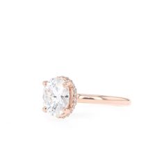 a rose gold engagement ring with an oval cut diamond