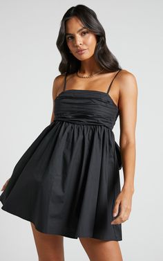 Clover Mini Dress - Back Bow Babydoll Dress in Black | Showpo USA Flirty Black Dress With Bow, Chic Mini Dress With Bow Straps, Bow Mini Dress For Day Out, Mini Dress With Bow For Day Out, Chic Dresses With Bow Straps For Night Out, Flirty Black Mini Dress With Bow, Chic Bubble Dress, Mini Length, Chic Mini Bubble Dress, Casual Mini Dress With Bow