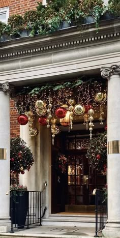 an entrance to a building decorated with christmas decorations