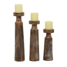 three wooden candlesticks sitting next to each other