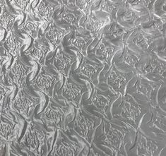 an abstract pattern is shown on the surface of a piece of metal foil that looks like it has been scratched or stained