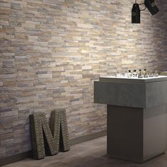 a modern bathroom with stone wallpaper and tile flooring is pictured in this image