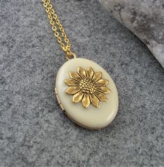 Gold Plated Cream Sunflower Locket. Gift For Women. Gold necklace pendant with a beautiful Cream enamel and two spaces inside for photos etc. This beautiful locket would make a perfect gift for birthdays, anniversaries, etc. The locket is hanging on a gold plated chain and you can choose your length at checkout. Measurements are 30 mm long, 25mm wide. Your locket will be gift boxed. All lockets are made to order, if you have a special requirement please let me know. Thank you for visiting my sho Nickel Free Cream Jewelry As Gift, Nickel-free Cream Jewelry For Gifts, Flower Shaped Locket Jewelry For Wedding, Vintage Pendant Jewelry As Gift For Mom, Flower Shaped Wedding Locket Jewelry, Floral Wedding Locket Jewelry, Wedding Flower Locket Jewelry, Vintage Cream Flower Jewelry, Vintage Flower Shaped Jewelry For Gift