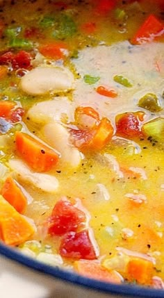 a pot filled with soup and vegetables on top of a stove