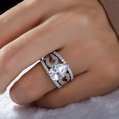 a woman's hand with a diamond ring on it