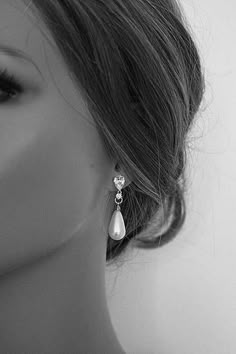 black and white photograph of a mannequin's head wearing earrings