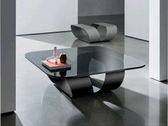 a modern glass coffee table in an empty room