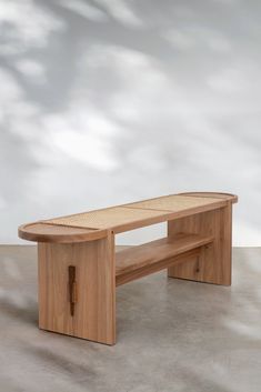 a wooden bench sitting on top of a cement floor