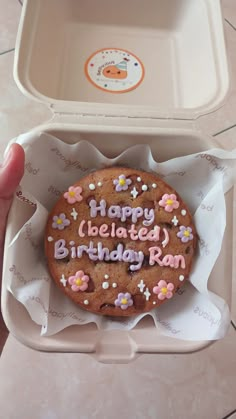 a happy birthday cookie in a box with writing on it