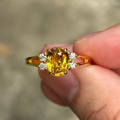 A stunning antique ring with Natural beryllium treated Yellow Sapphire (Certified - it's beryllium treated)  and Natural Diamonds on the Gold setting. The Yellow Sapphire has very nice color and clarity and the diamonds are very shining. it's very beautiful! -Second-hand- I think it's from around 20-30 years ago but I am not sure of the precise date. It's in very good condition - I have already re-polished the ring. Metal Type: 18k Gold Total Weight: 3.403 grams Dimensions: 11.47 mm. (From left to right) x 8.20 mm. (from top to bottom)  thinnest part of the band is 0.7 mm. (I put the dimensions of the ring in the last picture of this listing, Please check) Ring Size: 7 3/4 US (adjustable - Please feel free to contact me)   Center Gemstone and Accent Diamonds Gemstone: Natural Yellow Sapphi Yellow Oval Sapphire Ring With Prong Setting, Classic Yellow Sapphire Diamond Ring, Yellow Heirloom Ring With Prong Setting, Heirloom Yellow Ring With Prong Setting, Heirloom Yellow Rings With Prong Setting, Classic Yellow Sapphire Ring With Accent Stones, Classic Yellow Sapphire Ring With Prong Setting, Yellow Sapphire Ring With Accent Stones, Classic Yellow Sapphire Ring With Diamonds