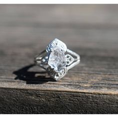 a diamond ring sitting on top of a wooden table