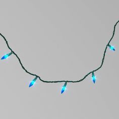 a string of blue christmas lights hanging from a wire