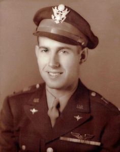 an old black and white photo of a man in uniform