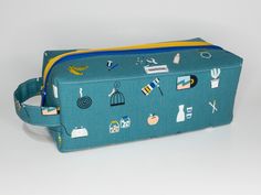 a blue toilet bag with various items on the front and side, all in different colors