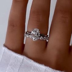 a woman's hand with a diamond ring on it