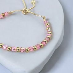 Dainty Pink Czech Fire Polish Crystals with Gold-Filled Beads.  Adjustable chain fits up to 8 inches. Great Gift for a Special Friend. Materials Gold Filled Adjustable chain Czech Fire Polish Pink 4mm Beads Gold Filled 3mm Beads Adjustable Gold Beaded Chain Friendship Bracelets, Adjustable Pink Chain Bracelet, Pink Adjustable Chain Bracelet For Party, Elegant Gold Charm Bracelet With Colorful Beads, Adjustable Pink Chain Bracelet For Party, Elegant Gold Friendship Bracelets With Colorful Beads, Pink Adjustable Charm Bracelet, Gold Crystal Bracelet With Beaded Chain For Gift, Adjustable Dainty Chain Bracelet With Round Beads