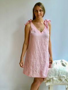 "Romantic pink linen night gown. Nightgown with regulating straps. Made from 100% pure linen. Simple. Eco-conscious. Smart choice. Available in soft white, creamy peach, natural taupe and black linens. For the best fitting of this dress please let us know the following measurements: - your height - your bust/waist/hip circumferences Each piece is individually cut, sawn and pre-washed. We really love making dresses for various sizes - from petit to plus size and more. Please allow for up to 10 DA Feminine Linen Dress For Vacation, Pink Linen Dress For Vacation, Feminine Linen Dress For The Beach, Feminine Linen Dress For Beach, Linen V-neck Dress With Tie Straps, Sleeveless Spring Dress For Relaxation, Sleeveless Spring Dress For Casual Wear, Pink V-neck Linen Dress For Beach, Summer Linen Sleep Dress