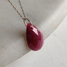 >>The pendant is made from Solid 14K Yellow Gold. Gemstone used is absolutely natural and ethically sourced.  >>Natural Ruby Precious Stone in pear shape is drilled with a minimalist gold bail with utmost precision. >>This is a minimalist design and is absolutely hassle-free and everyday jewelry. Gem: Ruby Gem shape: Pear checker cut Gem size: 12x20mm Gem weight: 10.80 cts Gold weight : 0.10 gram Gross weight : 2.26 gram The Gold purity is guaranteed and it comes with authentic 14K gold hallmark Gold Necklace Pendant, Gem Ruby, Lapis Pendant, Handmade Jewelry Box, Yellow Gold Necklace, Ruby Pendant, April May, Ruby Jewelry, June Birthstone