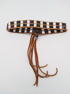 Handmade clay Wampum choker, armband or leg tie in traditional alternating purple and white.  Woven tightly onto deerskin lacing with purple glass Crow bead slide closures.  The beaded part is 15" with 7" of deerskin fringe.  This is made so that you simply slide the glass crow beads down, slip it over your head, then slide the beads back up to tighten it. Easy and simple! Fully adjustable.  Will fit necks, arms or legs that are 15" around or larger.  Proudly Native American made.   Traditionally, Wampum was made only by the women.  Women made the beads and women wove the belts.  In keeping with this indigenous tradition, all the clay Wampum beads in this piece are handmade by me. Wampum is the traditional shell bead of the Eastern Woodlands tribes of the indigenous people of North America Traditional Adjustable Purple Bracelet, Traditional Ceremonial Hand-strung Beaded Necklaces, Purple Hand-strung Bohemian Bracelet, Purple Hand-strung Bohemian Beads, Handmade Purple Multi-strand Beads, Eastern Woodlands, Woman Weaving, Deer Skin, Gift Exchange