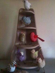 several birds are sitting on top of a shelf with hearts and other decorations around it