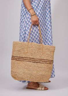 Our classic Luxe Striped Tote with black stripes is sure to brighten up your spring and summer! Packable for easy travel and roomie for all of your goodies. Optional leather loop to hold your favorite sunhat! Shop Black Material: 100% Raffia Straw, Handles- 100% Leather Measurements: 19" x 14"; Handle Drop- 9" Spot Cle Everyday Striped Straw Bag, Casual Striped Woven Straw Bag, Striped Straw Bag For Travel, Striped Travel Bags For Summer, Summer Beach Bag With Striped Lining, Striped Beach Bag For Everyday Summer Use, Casual Striped Straw Bag, Chic Striped Bags For Vacation, Casual Beach Bag With Striped Lining