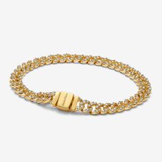 Elevate your look with the Pavé Cuban Chain Bracelet. This 14k gold-plated bracelet features sparkling links in a chain. The top of each half circle is set with three round stones, while the back of the chain is polished for shine and comfort. The bracelet closes with a flat, square-shaped clasp featuring an engraved Pandora logo. - Pandora Pavé Cuban Chain Bracelet - 14k Gold-plated unique metal blend / Cubic Zirconia / Clear - Sz. 7.9 in Classic Chain Bracelet With Cubic Zirconia, Elegant Curb Chain Bracelet With Cubic Zirconia, Formal Cubic Zirconia Chain Bracelet, Tarnish Resistant, Classic Cuban Link Cubic Zirconia Bracelets, Diamond Curb Chain Bracelets For Formal Occasions, Luxury Cubic Zirconia Chain Link Jewelry, Elegant Cuban Link Tennis Bracelet, Luxury Diamond Curb Chain Bracelets, Elegant Gold Tennis Bracelet With Curb Chain