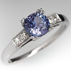 This alluring ring is centered with a no heat Tanzanian sapphire weighing 1.75 carats that we sourced and set in an elegant vintage platinum mounting. The shoulders of the ring are each accented with two (2), bead set, old European/single cut diamonds. The ring measures 7.0mm at the top, rises 7.2mm above the finger, tapering to 1.6mm wide and 1.2mm thick at the base of the shank. This ring is currently a size 9.75. Classic Sapphire Rings In Purple, Elegant Purple Sapphire Ring With Center Stone, Classic Sapphire Tanzanite Solitaire Ring, Classic Tanzanite Solitaire Sapphire Ring, Classic Tanzanite Diamond Ring In White Gold, Classic Sapphire Ring With Tanzanite Accent Stones, Classic Purple Sapphire Ring For Wedding, Classic Purple Sapphire Wedding Ring, Classic Purple Sapphire Ring With Prong Setting