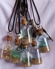 This ocean scenery bottle necklace features mini glass bottles with a blend of water, sand, seashells and resin, artfully arranged to create a breathtaking underwater seascape. The captivating design makes a unique statement piece, ideal for any beach or ocean-inspired outfit. Beach Sand Necklace, Mini Glass Bottle Necklace, Sand And Seashells In Jar, Mini Bottles Ideas, Ocean Themed Accessories, Seashell Resin Art, Mini Glass Bottles Ideas, Beach Room Decor Ideas, Beach Sand Crafts