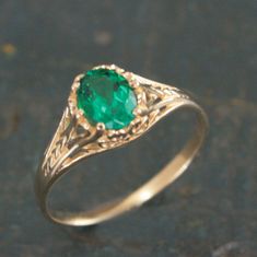 Oval Emerald Ring Filigree 14K Yellow Gold Ring 6 Prong Vintage Style Setting Antique Style Ring May Birthstone Ring Aurora Green Stone Ring To awaken from true loves first kiss, that is what we remember from Sleeping Beauty. Aurora was the princess' name. This beautiful ring emanates with Victorian style elegance and class. The delicate filigree encases the oval Emerald (quality your choice) which is held by 6 prongs. The stunning green stone measures 5mm by 7mm. The ring spans 7.5mm at the wid Yellow Gold Emerald Ring, Luxury Green Oval Engraved Ring, Emerald Gold Ring Vintage, Victorian Yellow Gold Emerald Ring, Formal Rings With May Birthstone In Round Band, Formal May Birthstone Round Band Ring, 14k Gold Ring For Formal May Birthstone, Formal 14k Gold Emerald Birthstone Ring, 14k Gold Formal Ring With May Birthstone