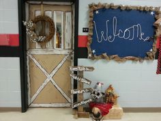 a welcome sign is displayed in front of the door to a school room decorated for christmas