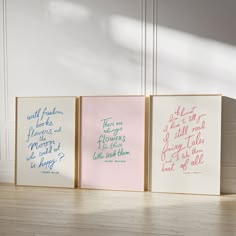 three canvases with different quotes on them sitting on a wooden floor in front of a white wall