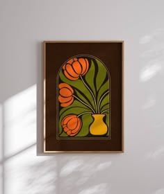 a painting hanging on the wall next to a vase with flowers in it and sunlight coming through