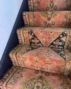 a carpeted stair case with an intricate design on it