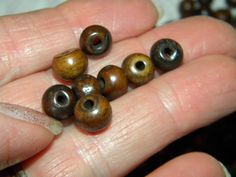 a person holding several beads in their hand